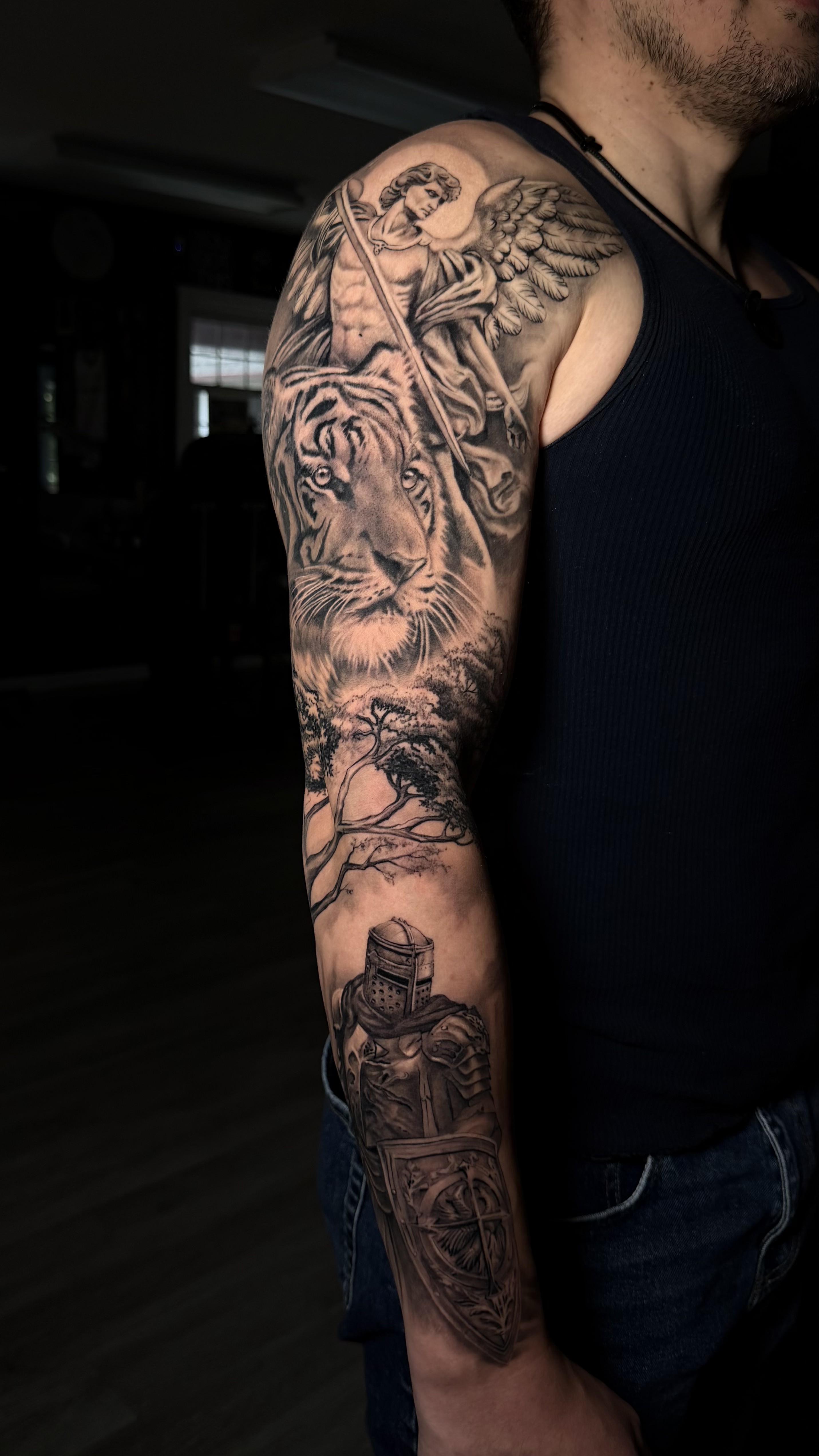 Photorealistic bear portrait tattoo in black and grey on calf leg